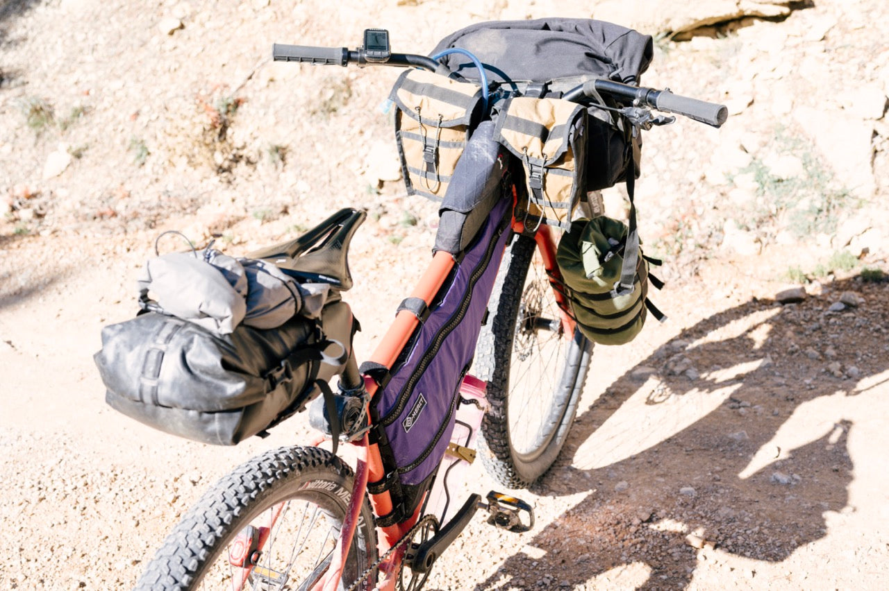 What is a non-suspension corrected bike and why is it better for bikepacking?